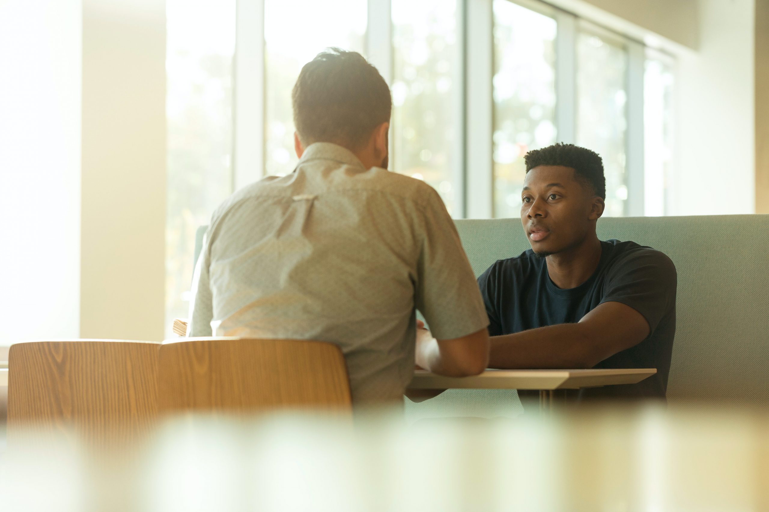 Photograph of two people talking about antimicrobial resistant infections